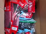 a cardboard box filled with assorted clothing and a pair of scissors