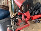 a red machine that is sitting on top of a wooden table
