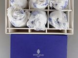 the box is filled with white and blue cloths on a white surface