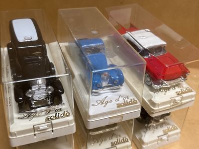 three cell phones that are in a display case