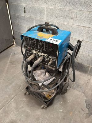 an image of a portable welding machine in a garage
