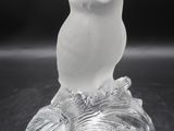 clear glass figurine of an owl sitting on a tree branch