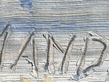a close up of a piece of wood with writing on it