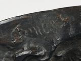 a bronze sculpture of a dog and a cat on a rock