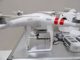 a white and red drone sitting on top of a table