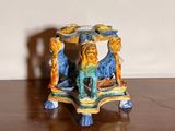 a small table with a lion on it on a wooden floor