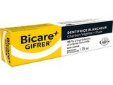 un tube de dentifrice sur lequel est posée une brosse à dents