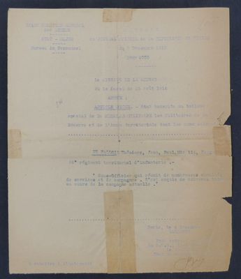 an old document with a piece of paper on top of it