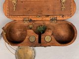 an old wooden box with two bowls inside of it