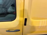 a yellow van that is parked on the side of the road