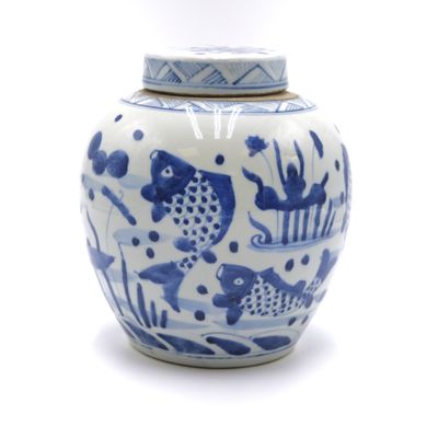 a blue and white vase with a lid on a white surface