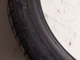 a close up of a tire on a white surface with a black rim
