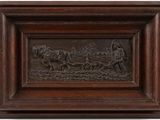 a close up of a wooden plaque with a horse drawn carriage