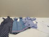 a pile of clothes on a table next to a wall