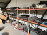 many different types of tools on the shelves in the garage