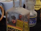 a bottle of anisette bergerger sitting on a table next to other bottles
