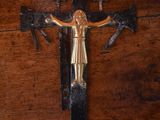a cross with a woman on it on a wooden table