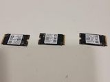 a close up of three memory modules on a white surface