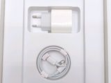 a white box with a charger and a cable in it