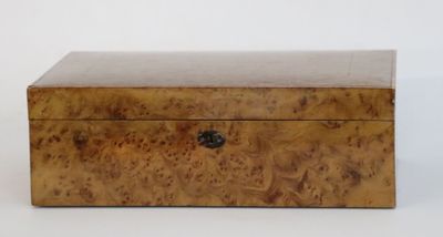 a small wooden box sitting on top of a white surface