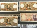 four different types of currency are displayed in a display case