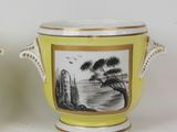 pair of yellow and white vases with a painting on them