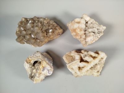 four different kinds of rocks on a white surface