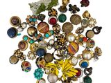 a pile of assorted jewelry on a white surface