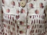 a dress on a mannequin stand with a button on it
