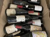 many bottles of wine in a box on the floor