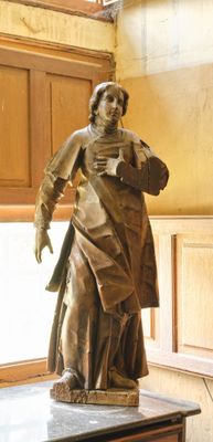 a statue of a woman standing on a table in a room