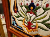 a close up of a decorative tile with flowers on it