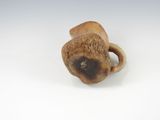 an image of a small wooden object on a white surface