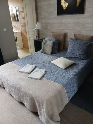 un lit sur lequel sont posés une couette bleue et des oreillers