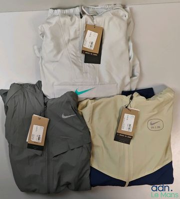 three pairs of men ' s nike jackets and a pair of pants