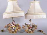 pair of lamps with figurines of people on them on a table