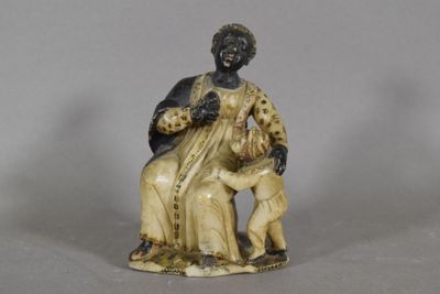 an image of a figurine of a woman sitting on a chair