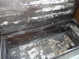 an old wooden chest with peeling paint on it
