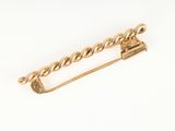 an image of a gold safety pin on a white background