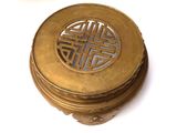 a small brass box with a design on it