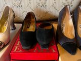 several pairs of shoes are sitting on top of a red box