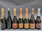 a group of six bottles of champagne sitting next to each other