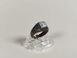 an image of a ring with a stone in it on a clear stand
