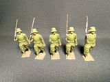 four figurines of soldiers in green uniforms are lined up