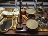 a wooden table with a lot of dishes and pans on it