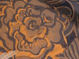 a close up of a plate with a flower design on it