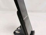 a cell phone that is on a stand on a table