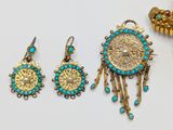 two pairs of turquoise and gold earrings and a pendant