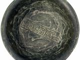 a black bowl that has a picture of a dragon on it