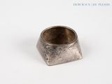 a silver ring sitting on top of a white surface